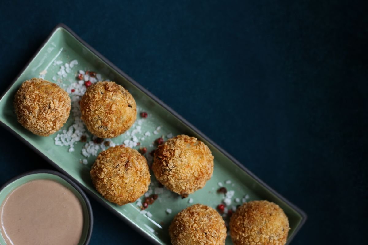 Golden arancini with a dipping sauce