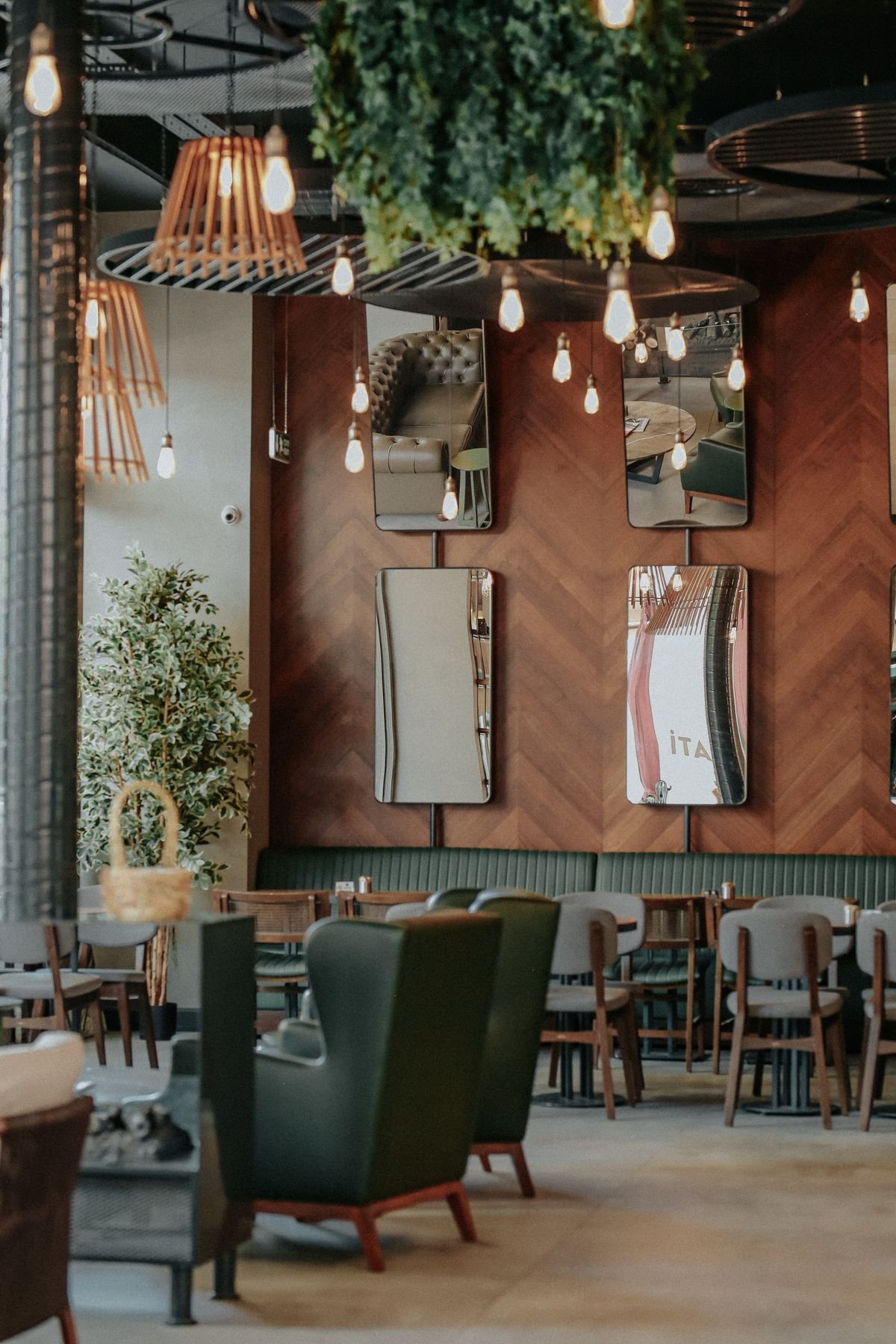 Restaurant seating with mirrors and hanging plants
