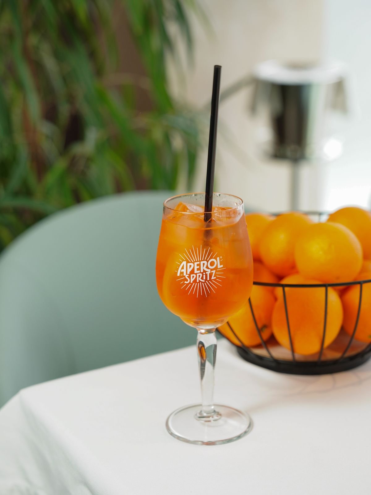 A spritz with orange garnish on a restaurant table
