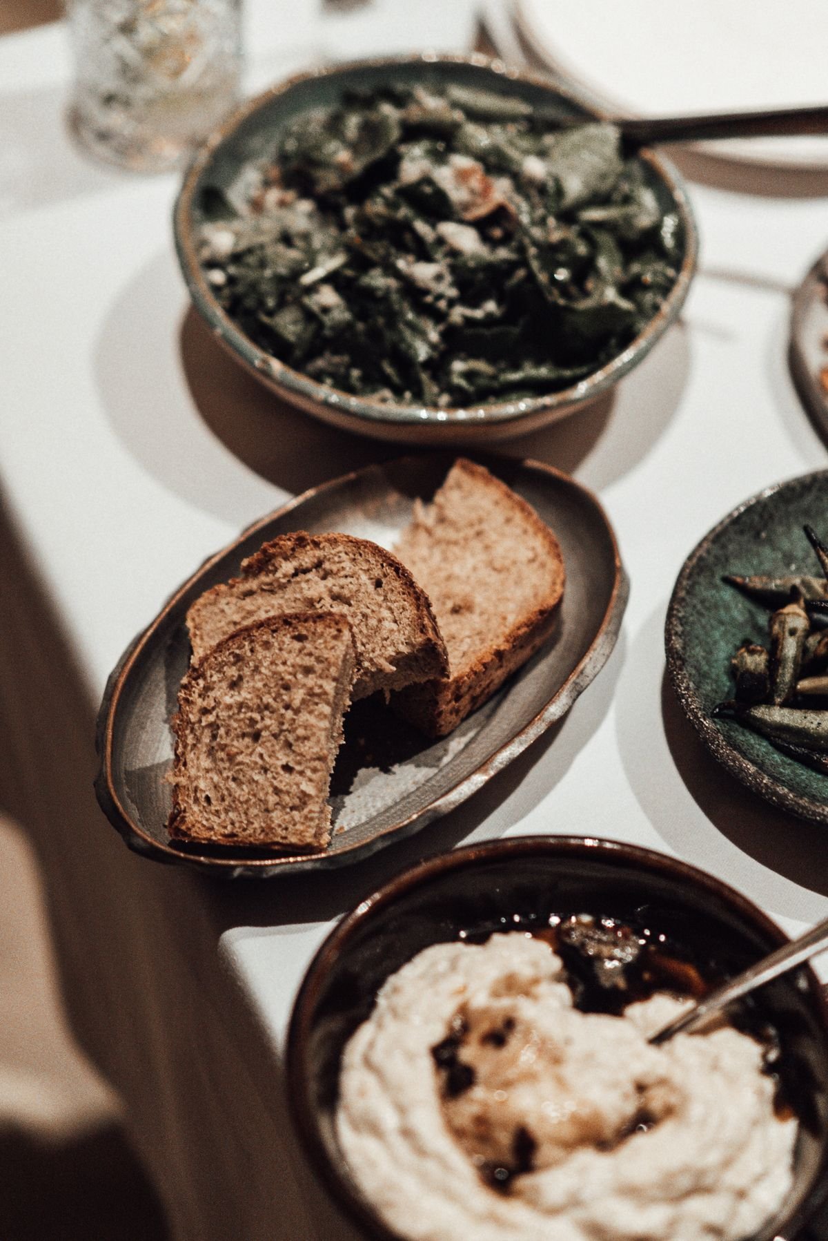 Bread, hummus and fresh salad arranged for sharing