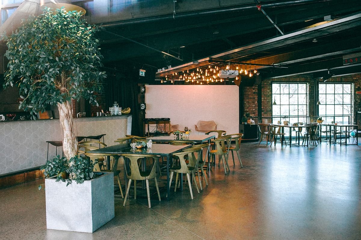 Airy cafe with wood furniture and a potted tree